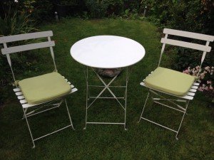 A white garden bistro cast iron table