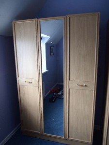 Double wardrobe with full length mirror in light oak veneer.