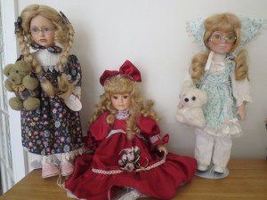 three porcelain dolls