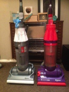 two Dyson vacuum cleaners
